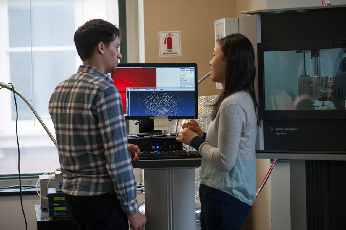 Two students gathered at a computer in one of Columbia's chemistry labs.